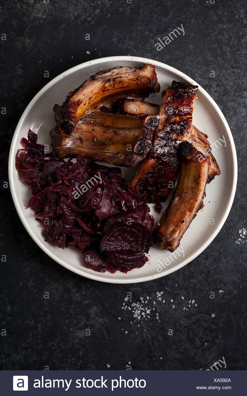 Grilled Pork Ribs Cooked With Balsamic Vinegar And Honey Sauce Garnished With Red Wine Braised Red Cabbage With Beets On White Plate Dark Rustic Bac Stock Photo Alamy