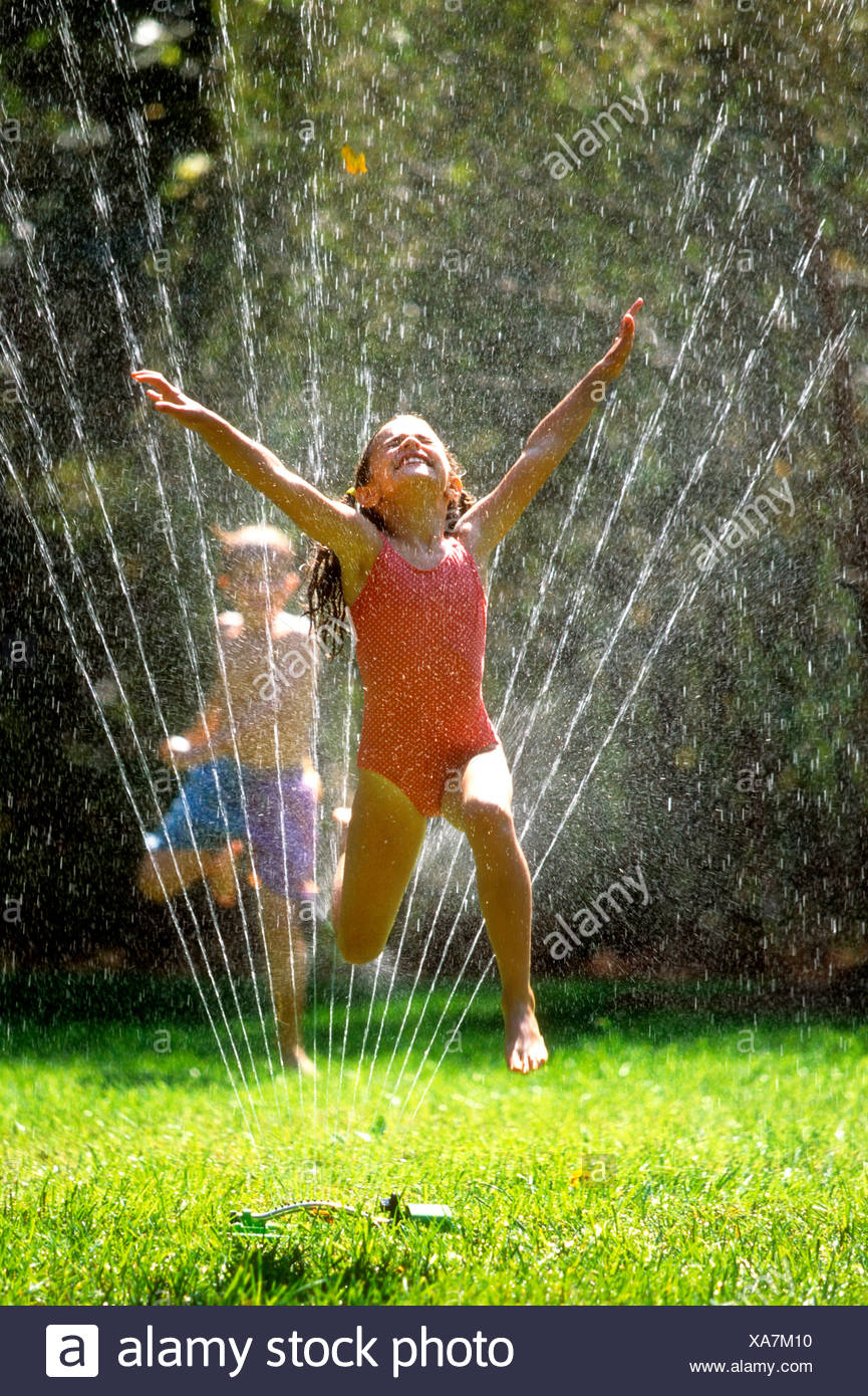 Girl Running Through Sprinkler Stock Photos & Girl Running Through
