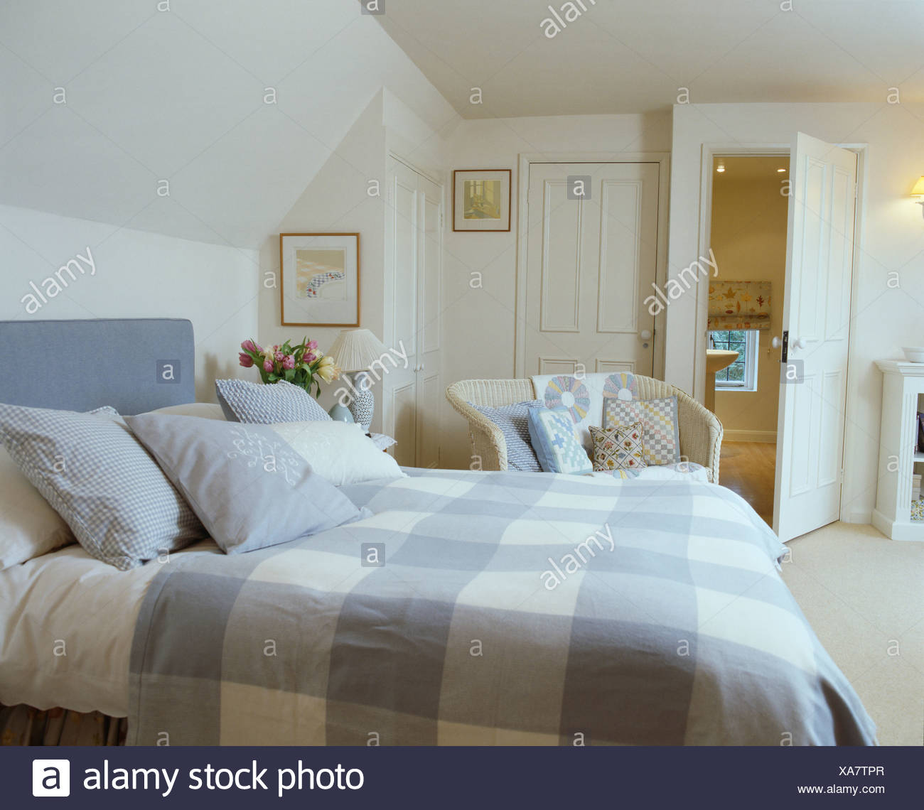 Blue White Check Bed Cover And Pale Blue Cushions On Bed