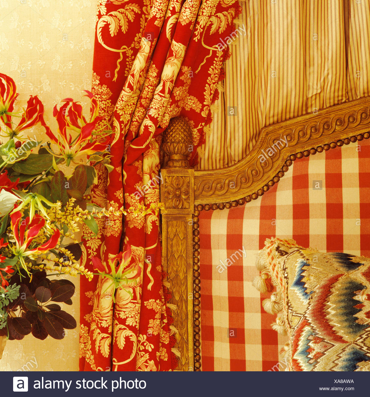 Close Up Of Red White Checked Upholstered Headboard And Red Floral
