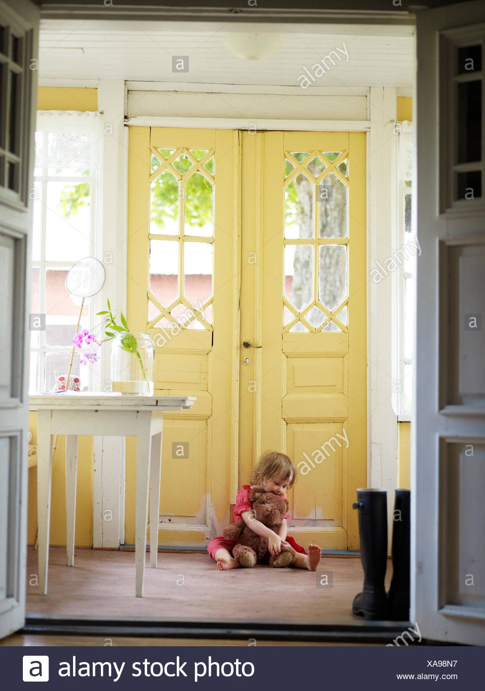 Girl With A Teddy Bear By A Outer Door Sweden Stock Photo