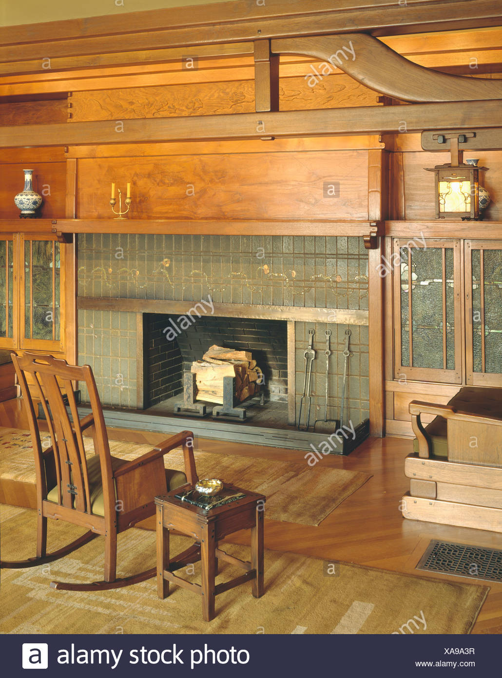 wooden table and rocking chair in front of fireplace in the