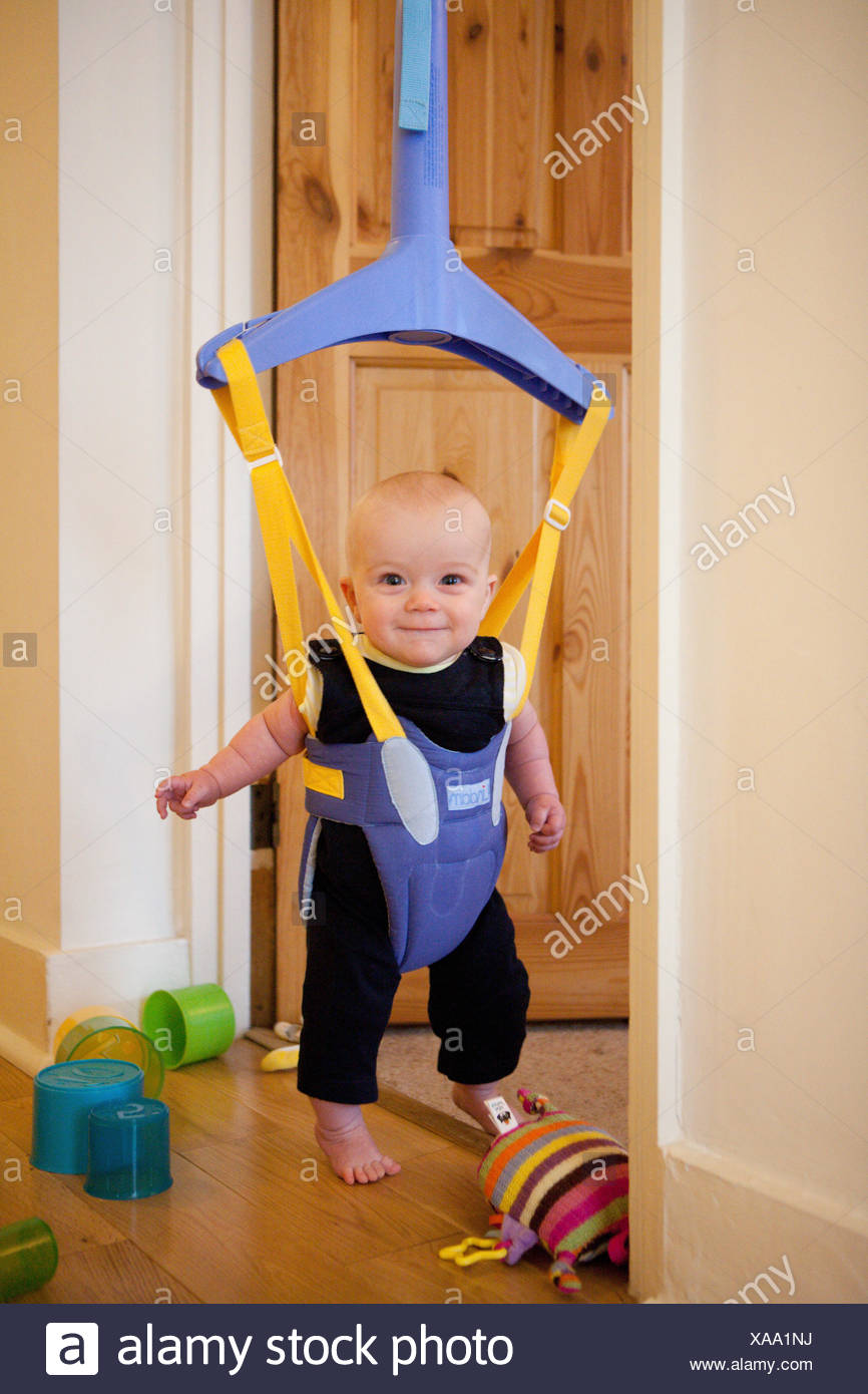 Baby in a door bouncer Stock Photo 