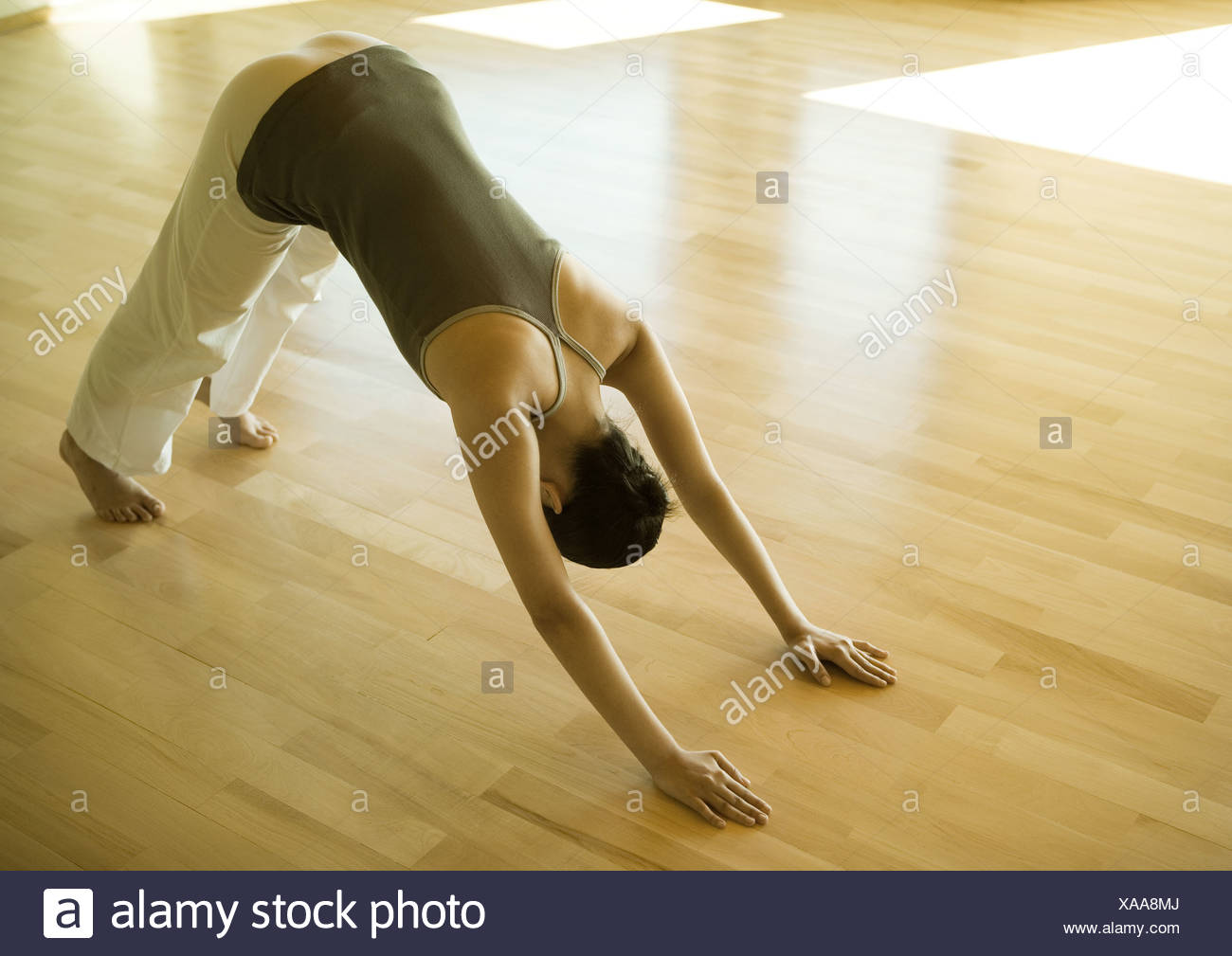 Woman Doing Downward Dog Pose Stock Photo Alamy