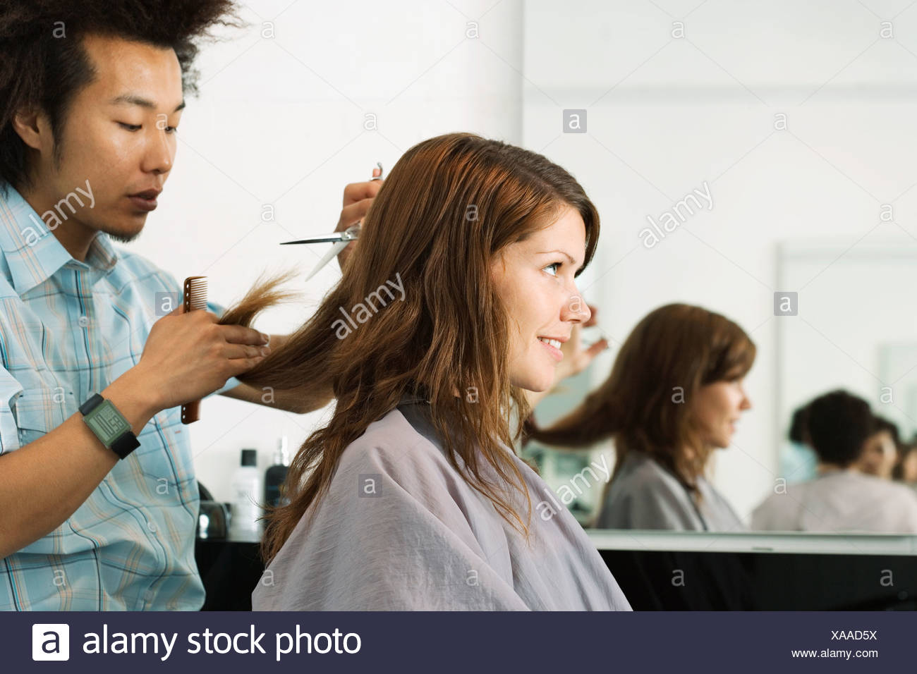 Young Male Hairdresser Cutting Woman S Hair In Salon Profile