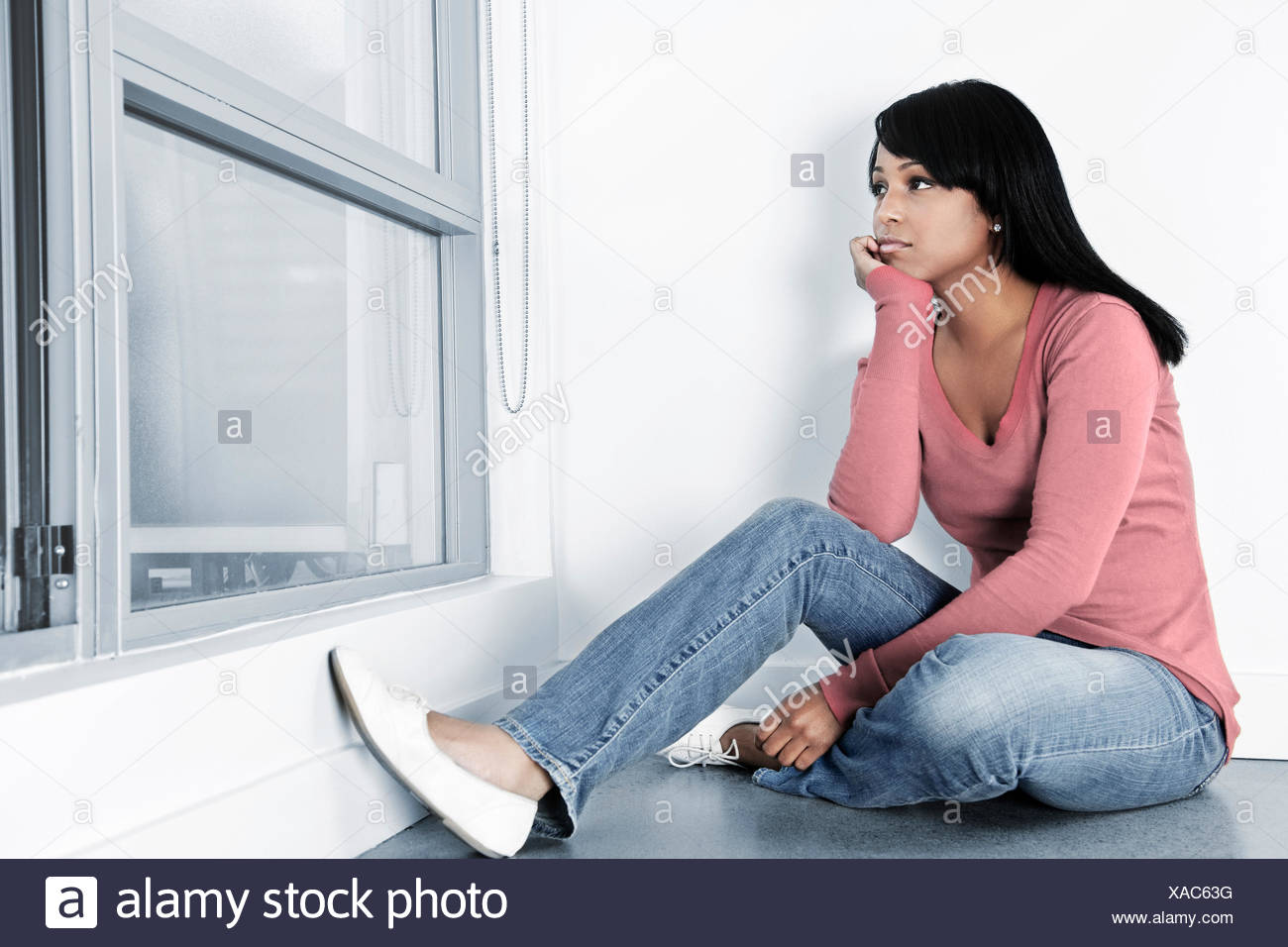 woman sad black swarthy jetblack deep black wall unhappy put sitting sit  Stock Photo - Alamy