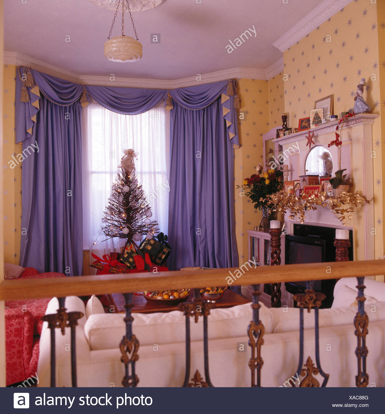 Purple Swagged And Tailed Curtains In Nineties Living Room Decorated For Christmas Stock Photo Alamy