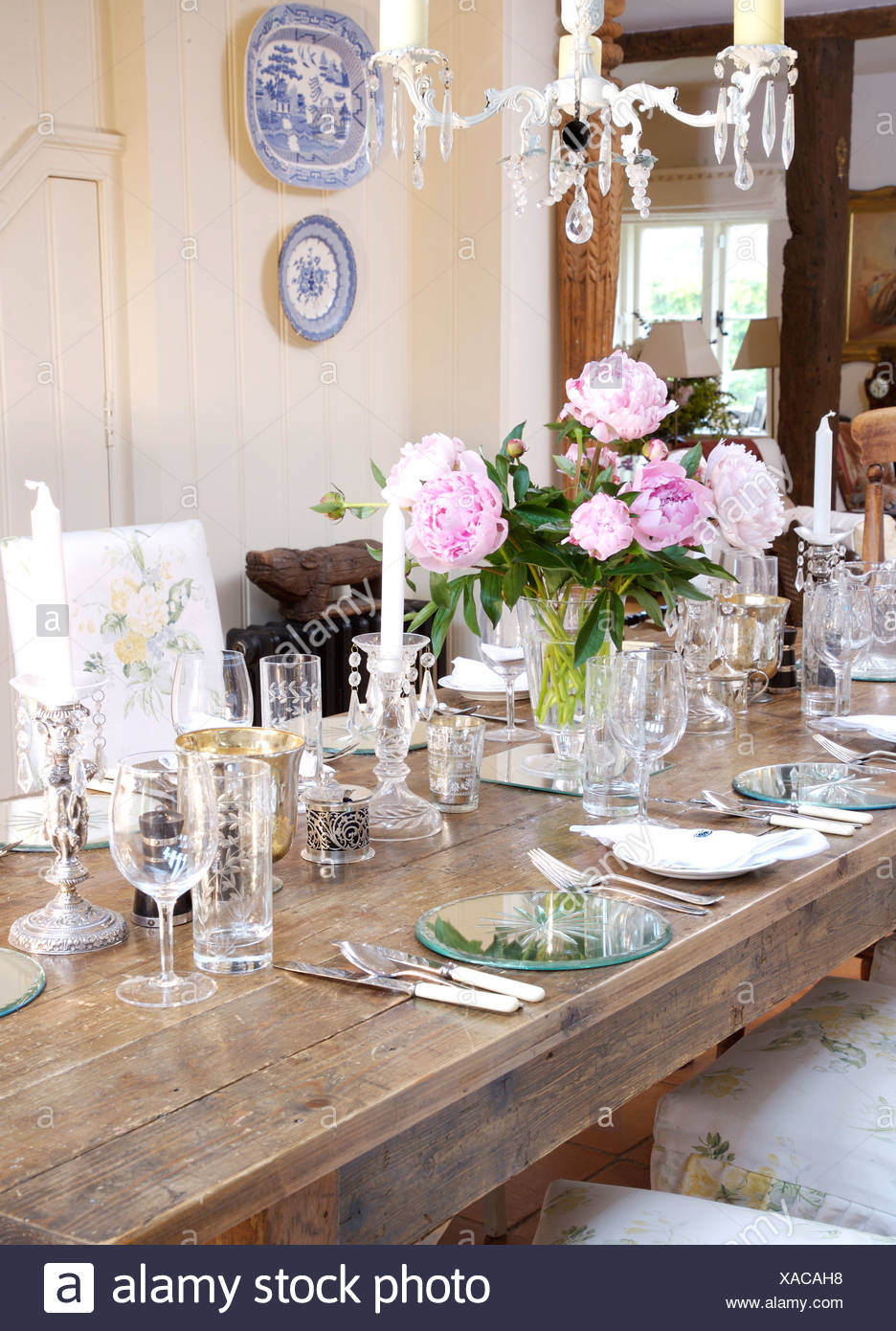 Table Set For Dinner On Rectangular Oak With Vase Of