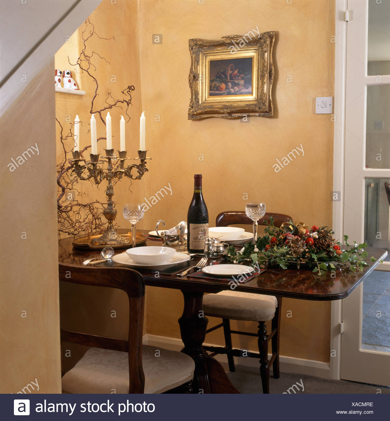 Table Set For Christmas Dinner With A Tall Candelabra And A