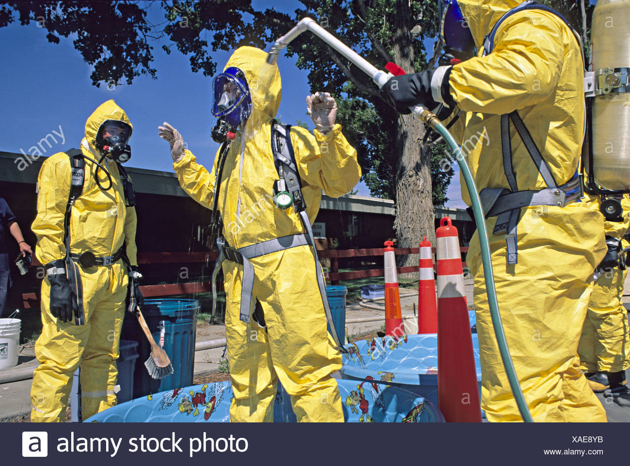 Hazmat Team Washes Member In Decontamination Line Stock Photo