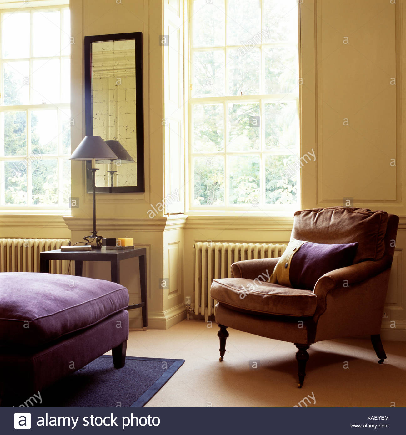 brown leather armchair in cream country bedroom with purple