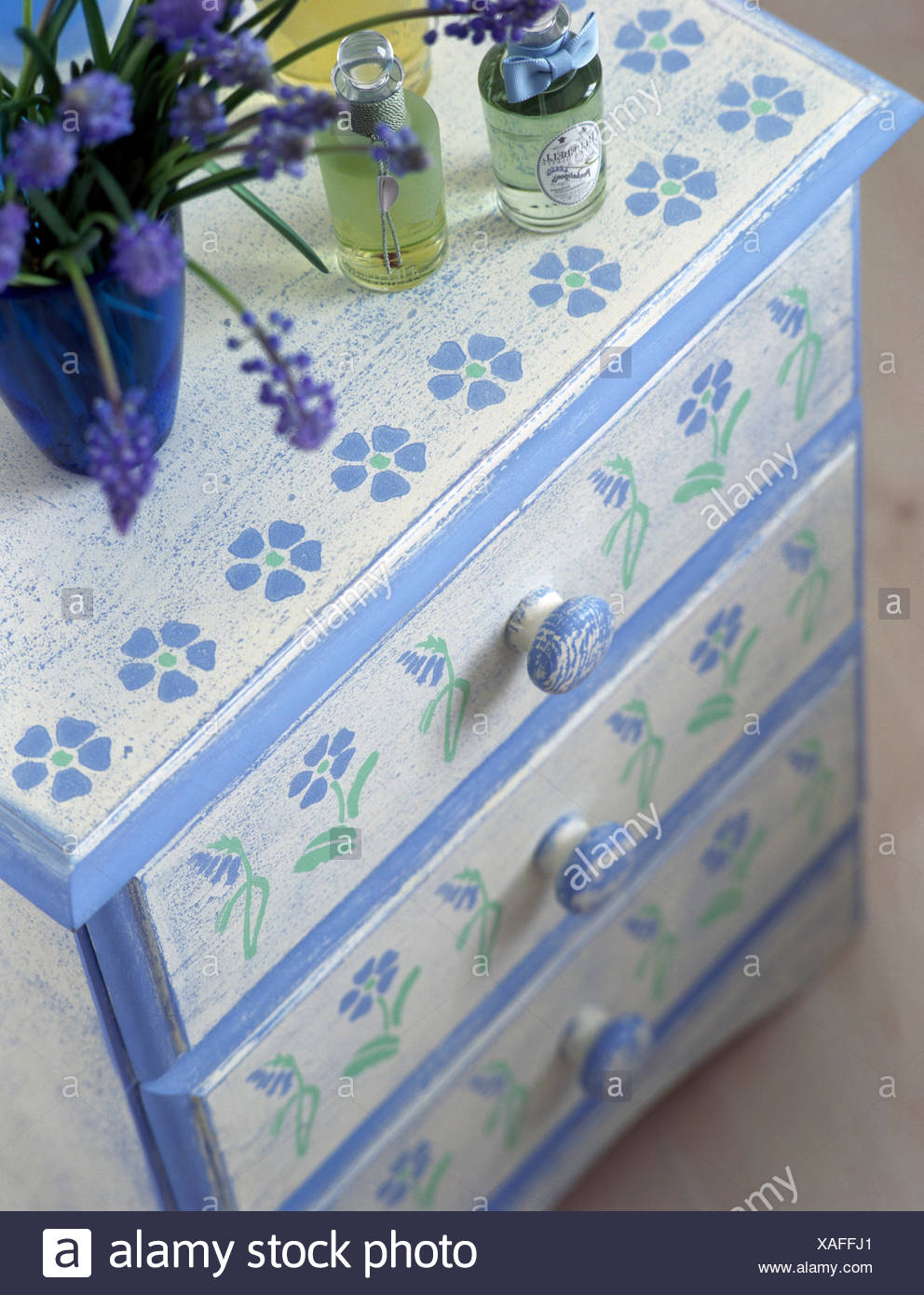 Close Up Of A Painted Chest Of Drawers With A Stenciled Floral