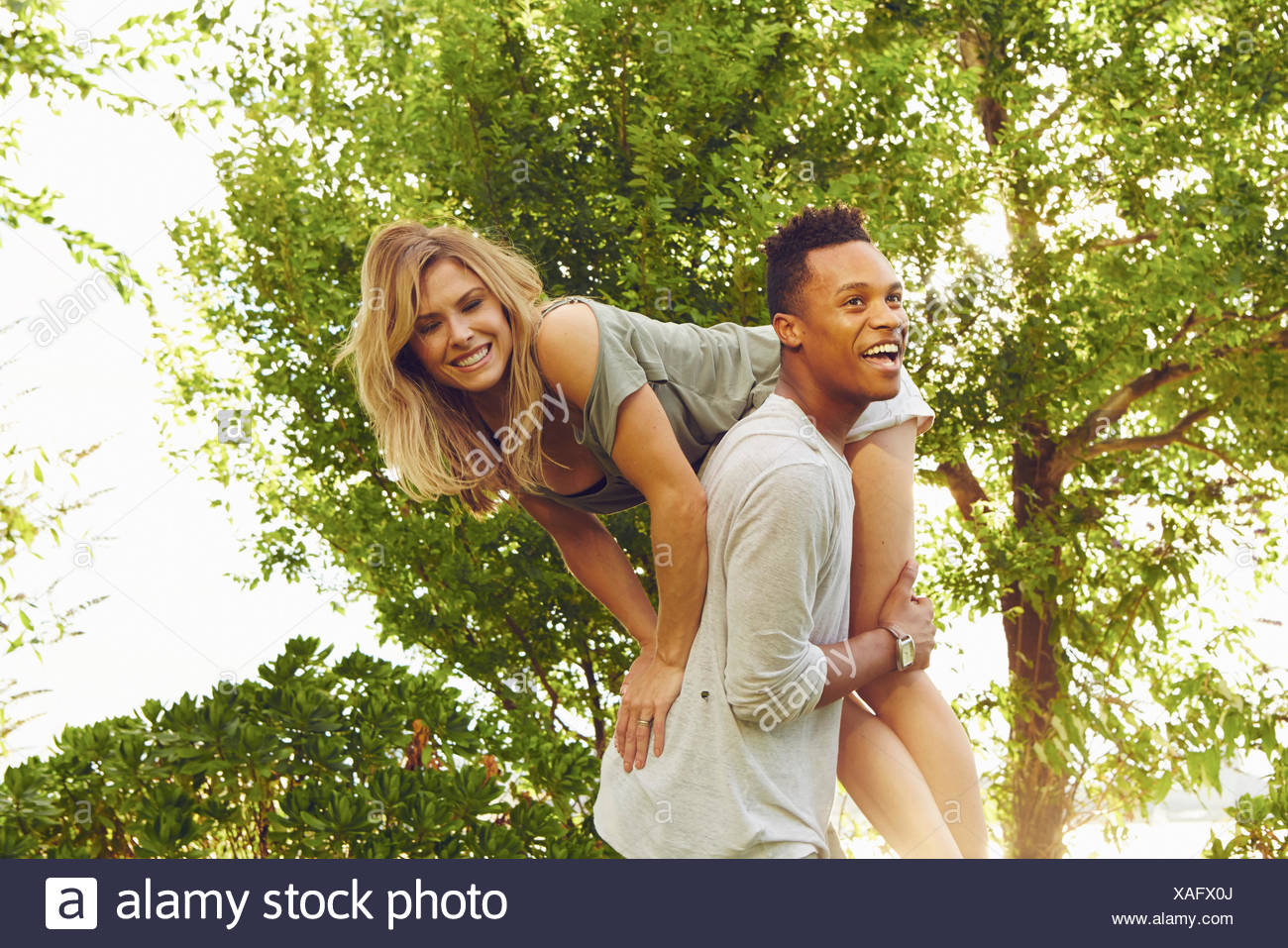 Man Carrying Woman Over Shoulder High Resolution Stock Photography and