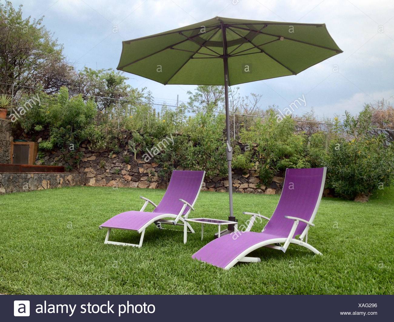 Patio Umbrella With Lounge Chair In Field Stock Photo Alamy