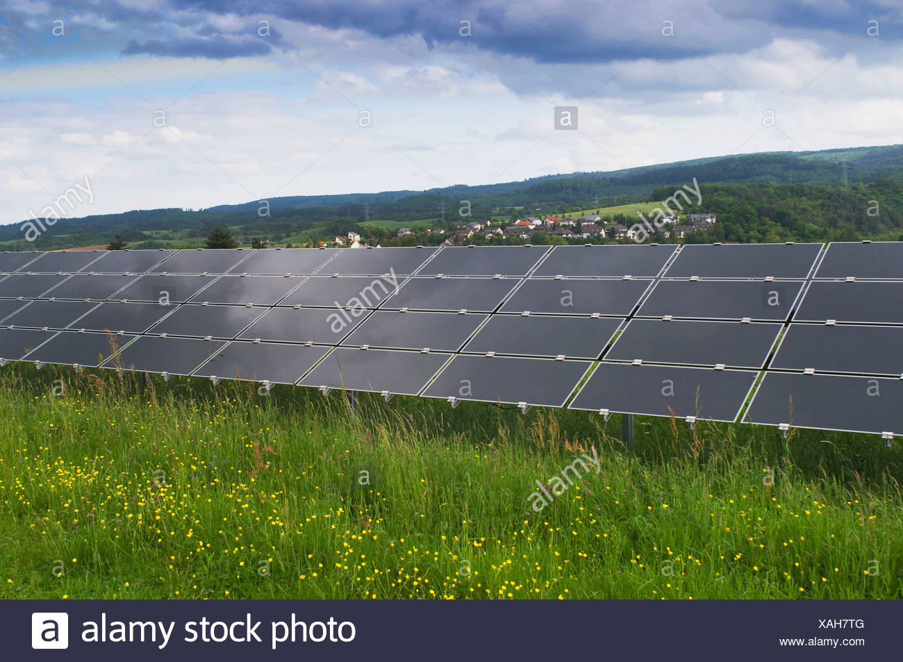 Solar power plant on a green field, photovoltaic system, view of a series of several modules Stock Photo