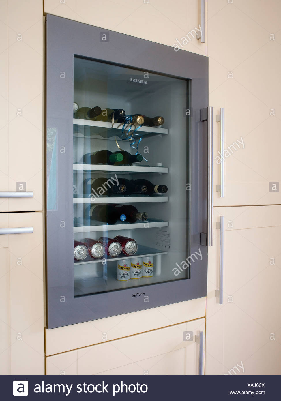 Close Up Of Refrigerated Drinks Cooler In Fitted Kitchen Cupboard