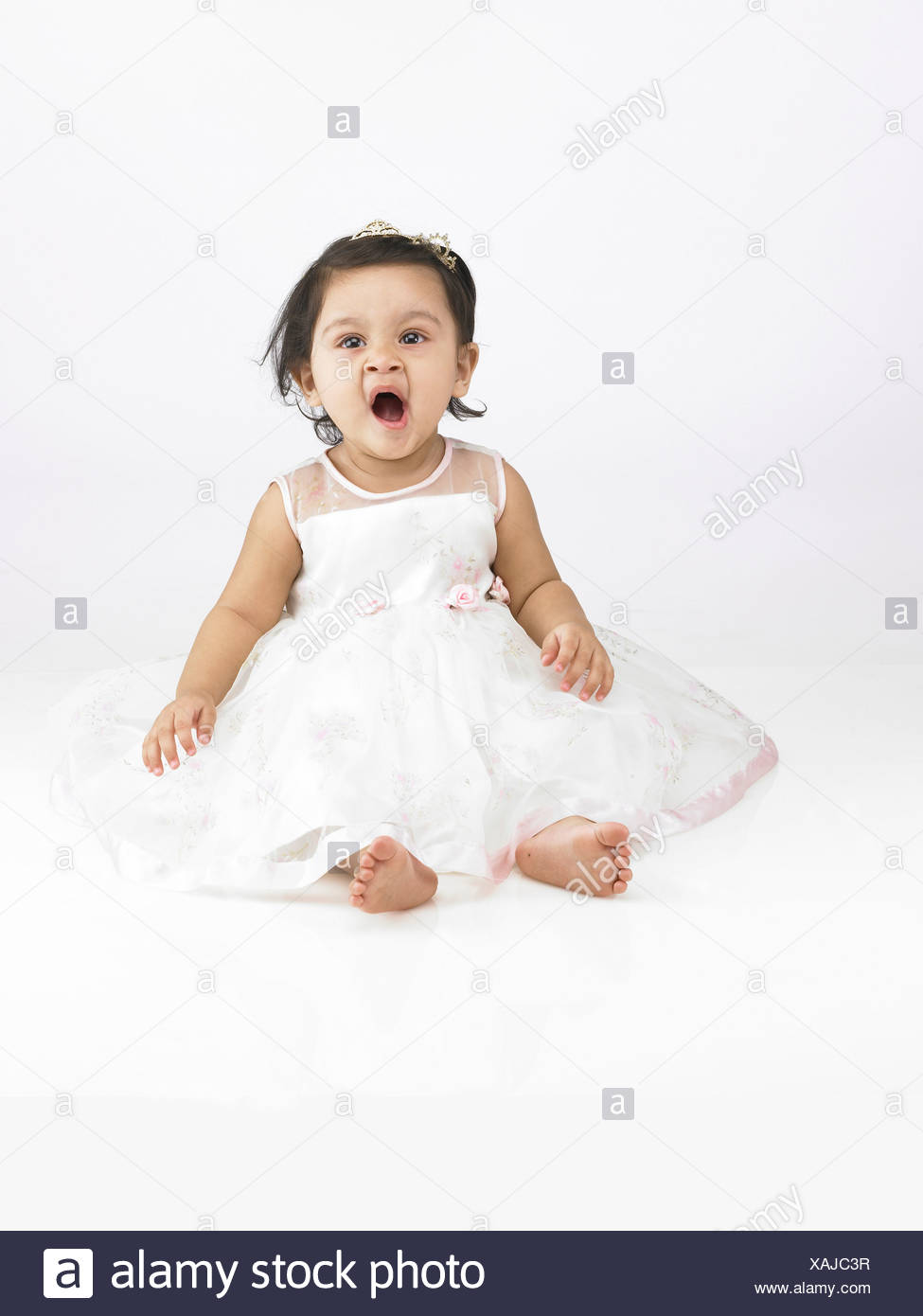 baby girl in white dress