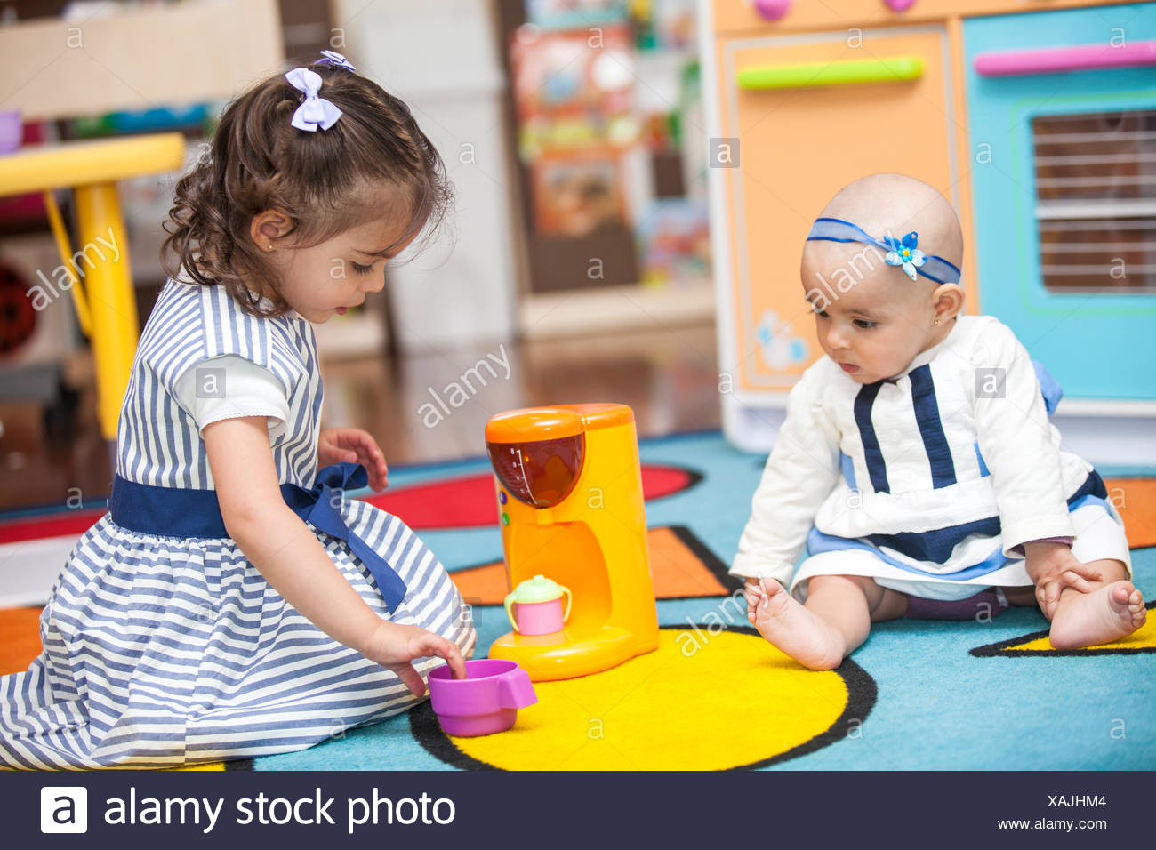 Two Little Girls Playing With Toy Kitchen Stock Photo 281921476
