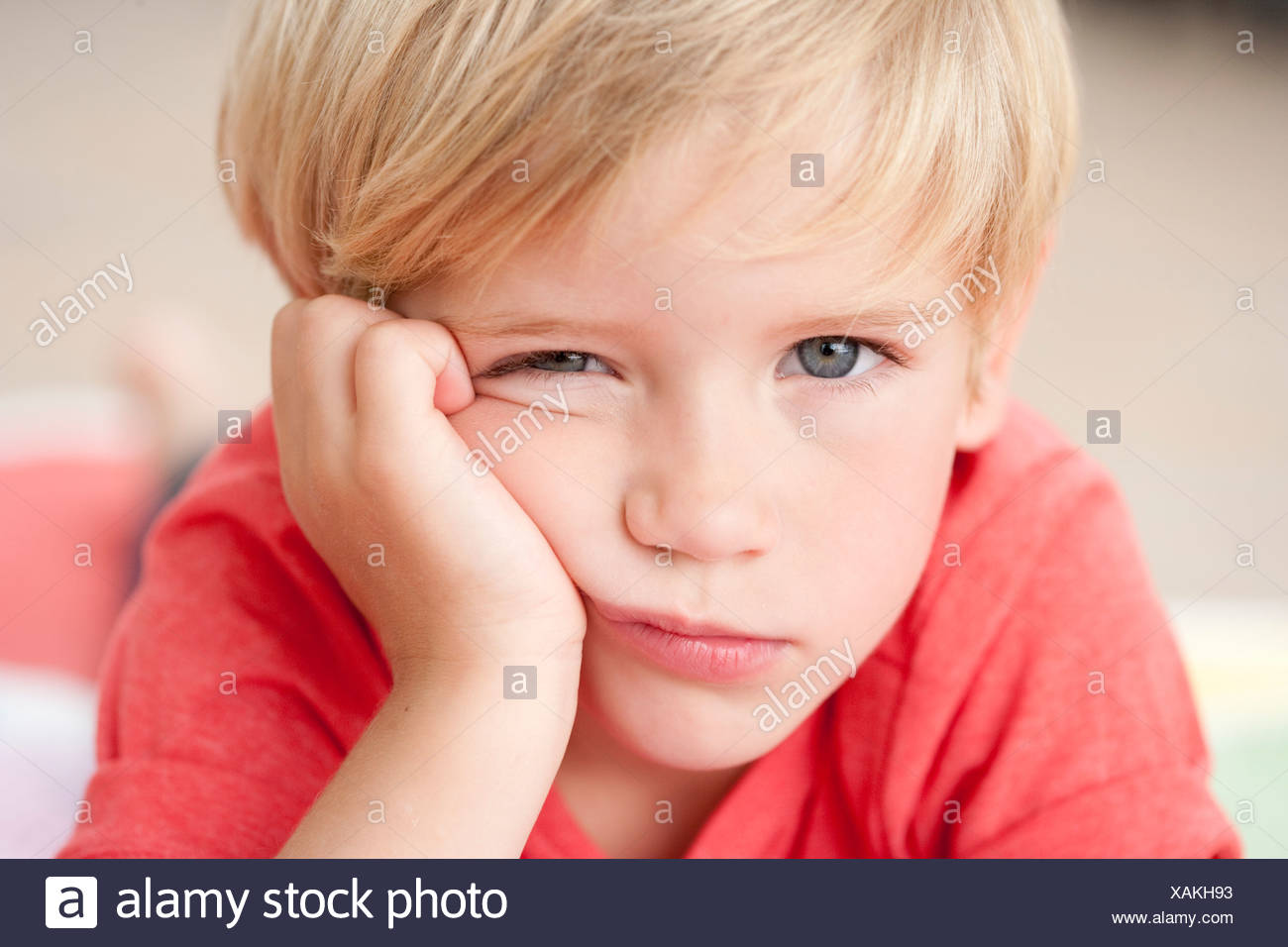 young boy looking bored at viewer Stock Photo