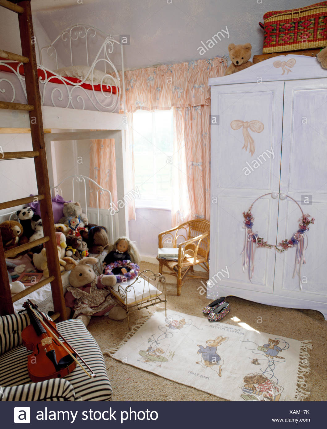 Painted Wardrobe With Painted Pink Bows In Child S Bedroom