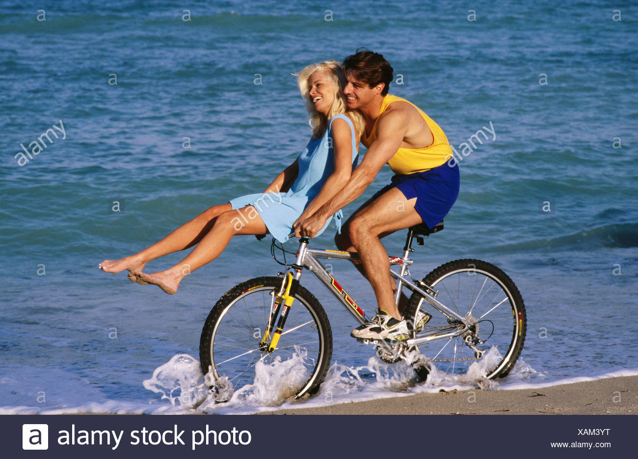 riding on the handlebars of a bike