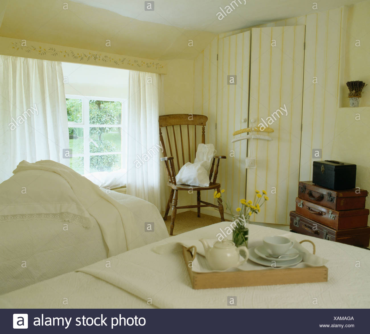 Breakfast Tray On Bed In Country Bedroom With Yellow Cream