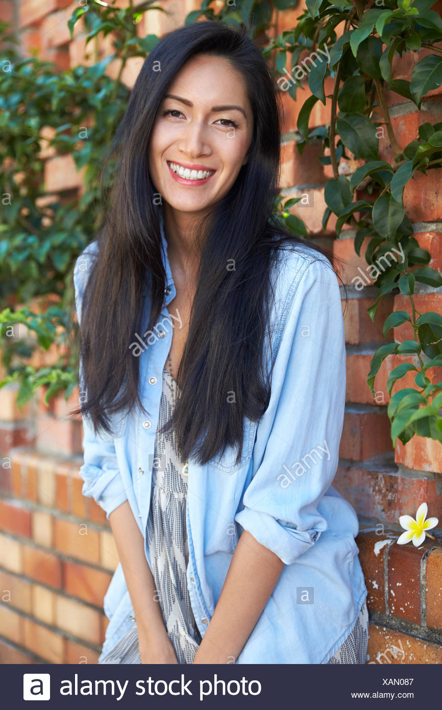 Mixed Race Asian Woman Looks To Camera Three Quarter Length Stock
