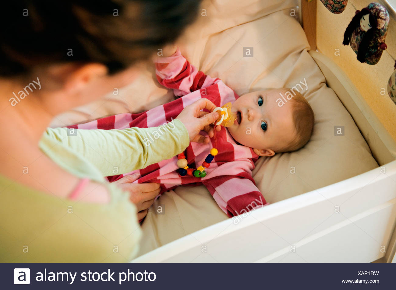 Mother Giving Comforter To Her Baby In Bed Stock Photo 281996845