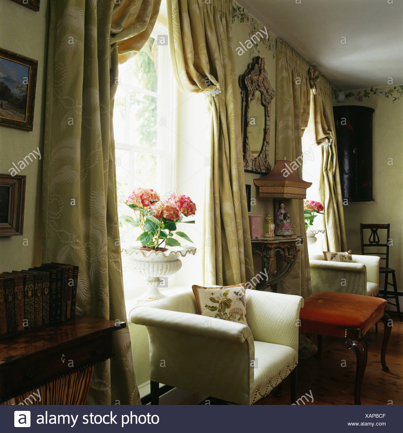 Cream Armchair In Front Of Window With Heavy Silk Curtains In Country Living Room Stock Photo Alamy