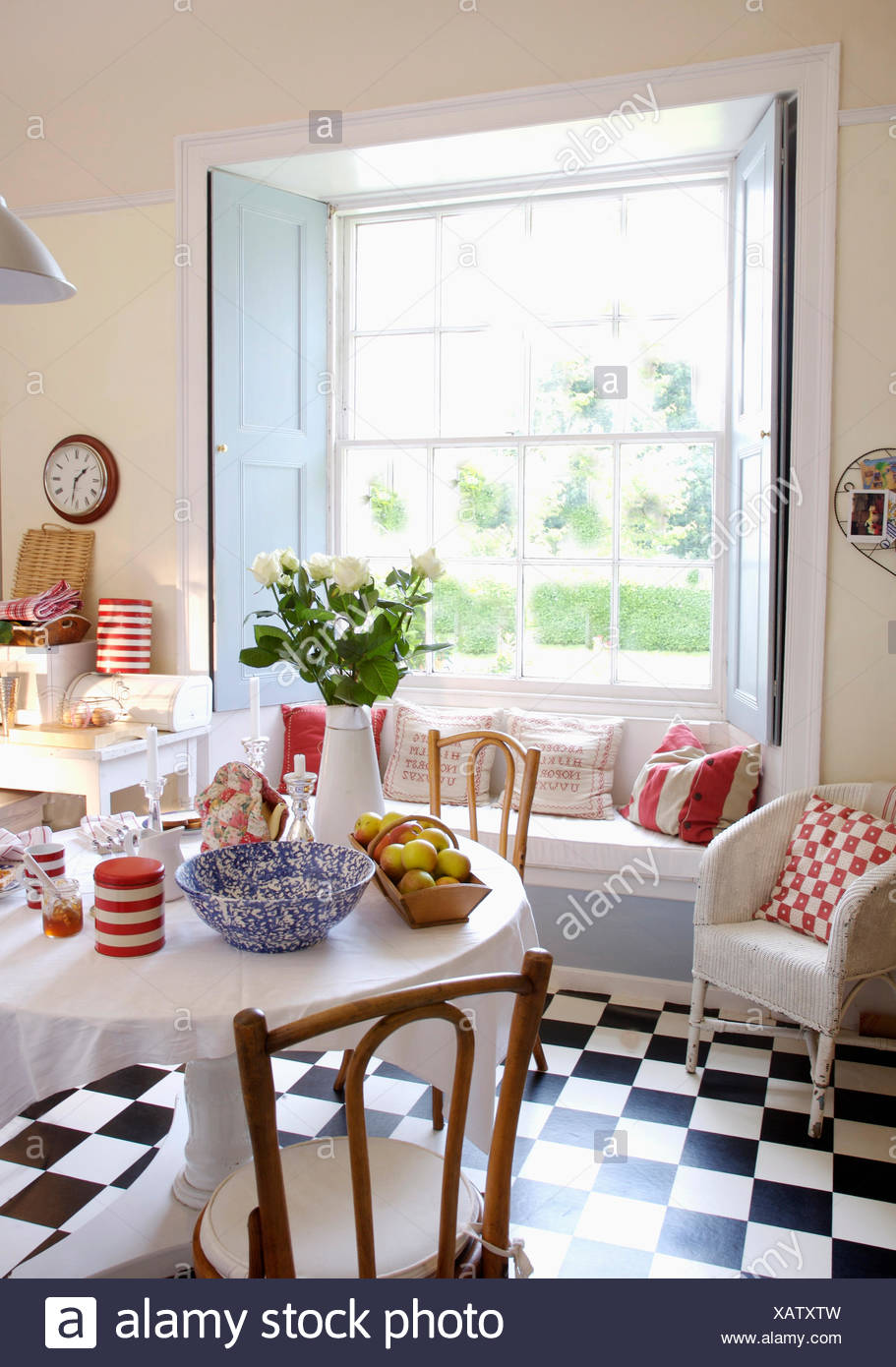 Black And White Flooring In Dining Room With Windowseat And Pastel