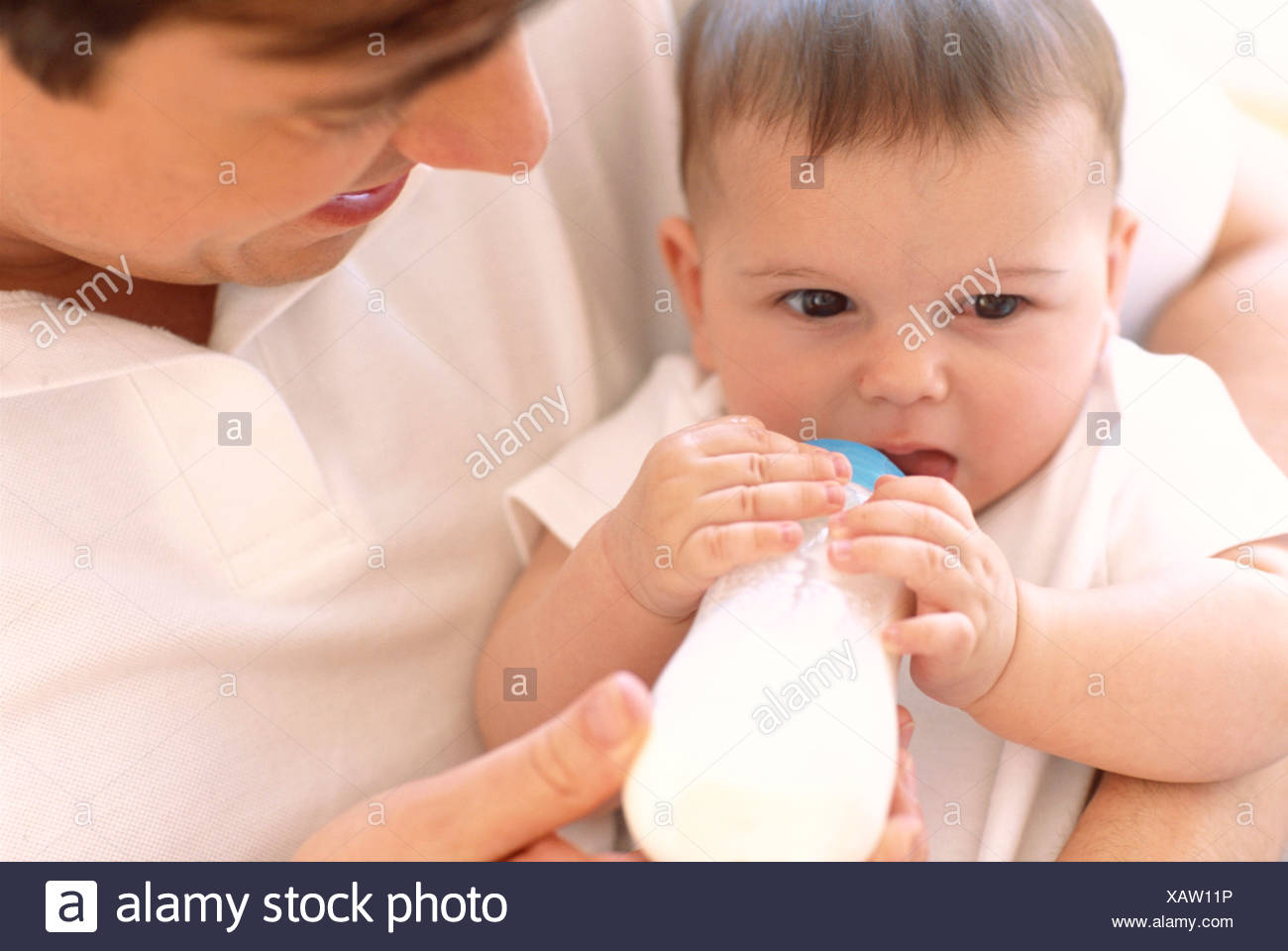Father Bottle Feeding Baby Father Using A Bottle To Feed Milk To