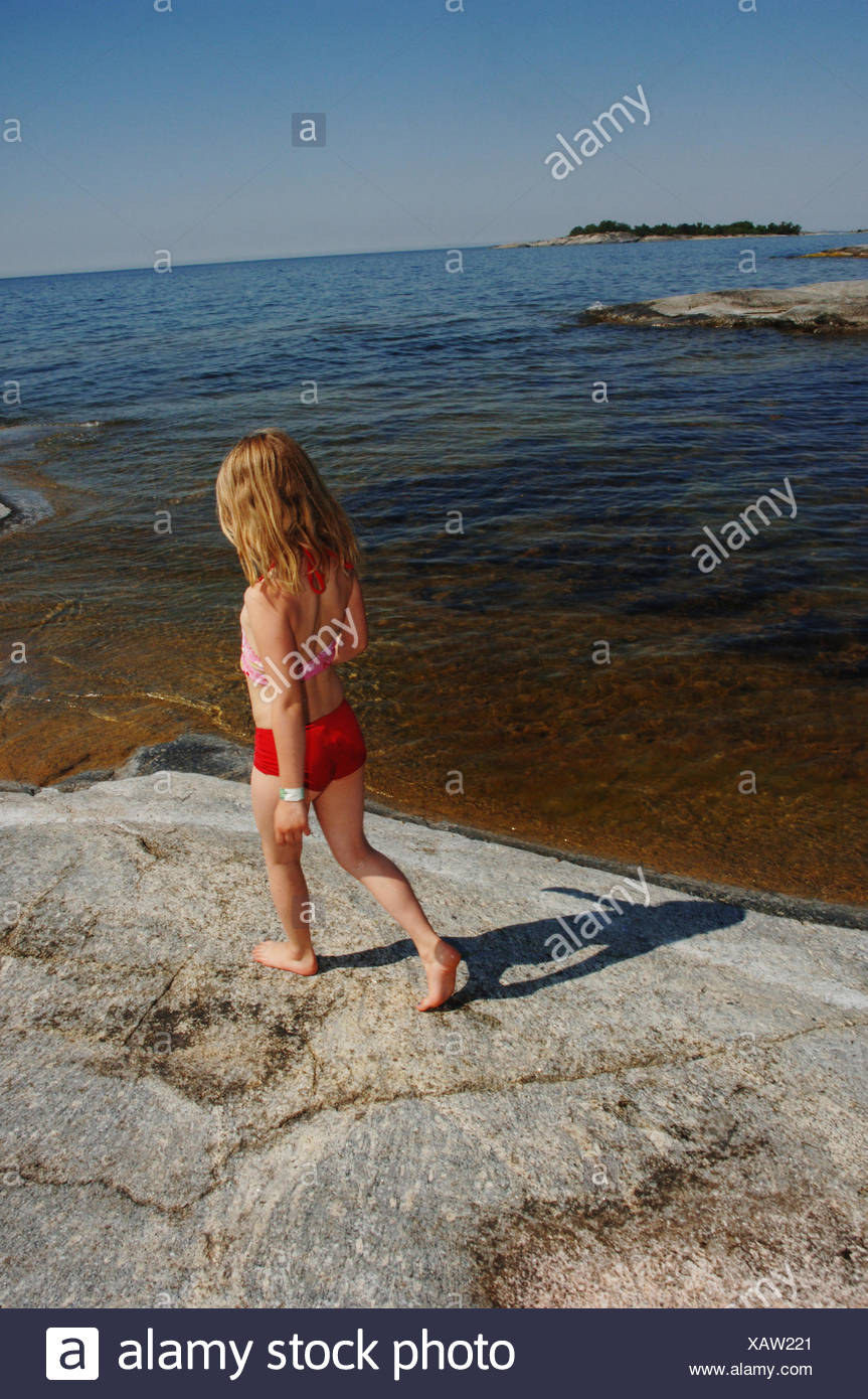 Girl On A Rock By The Sea Sweden Stock Photo Alamy