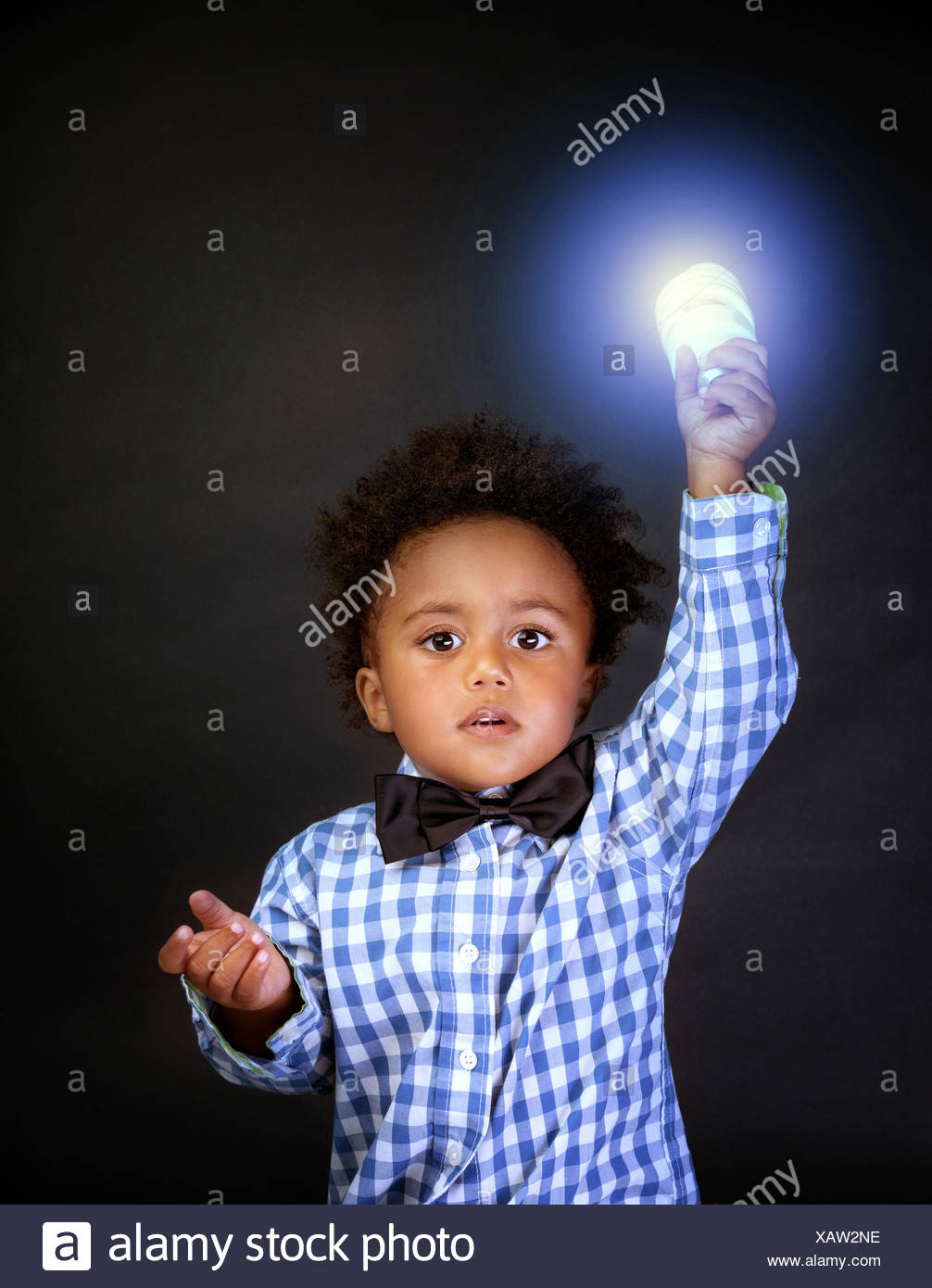 Little genius with illuminated lamp in hand isolated on black background,  african boy is a great physics, back to school concept Stock Photo - Alamy