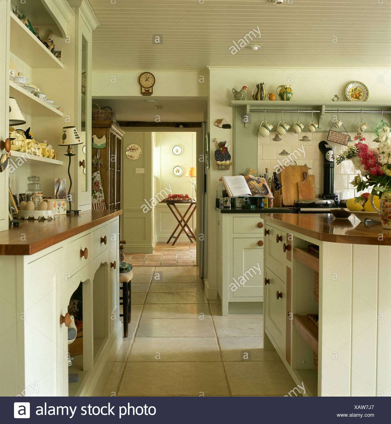 Fitted Dresser And Pale Cream Fitted Units In Country Kitchen With