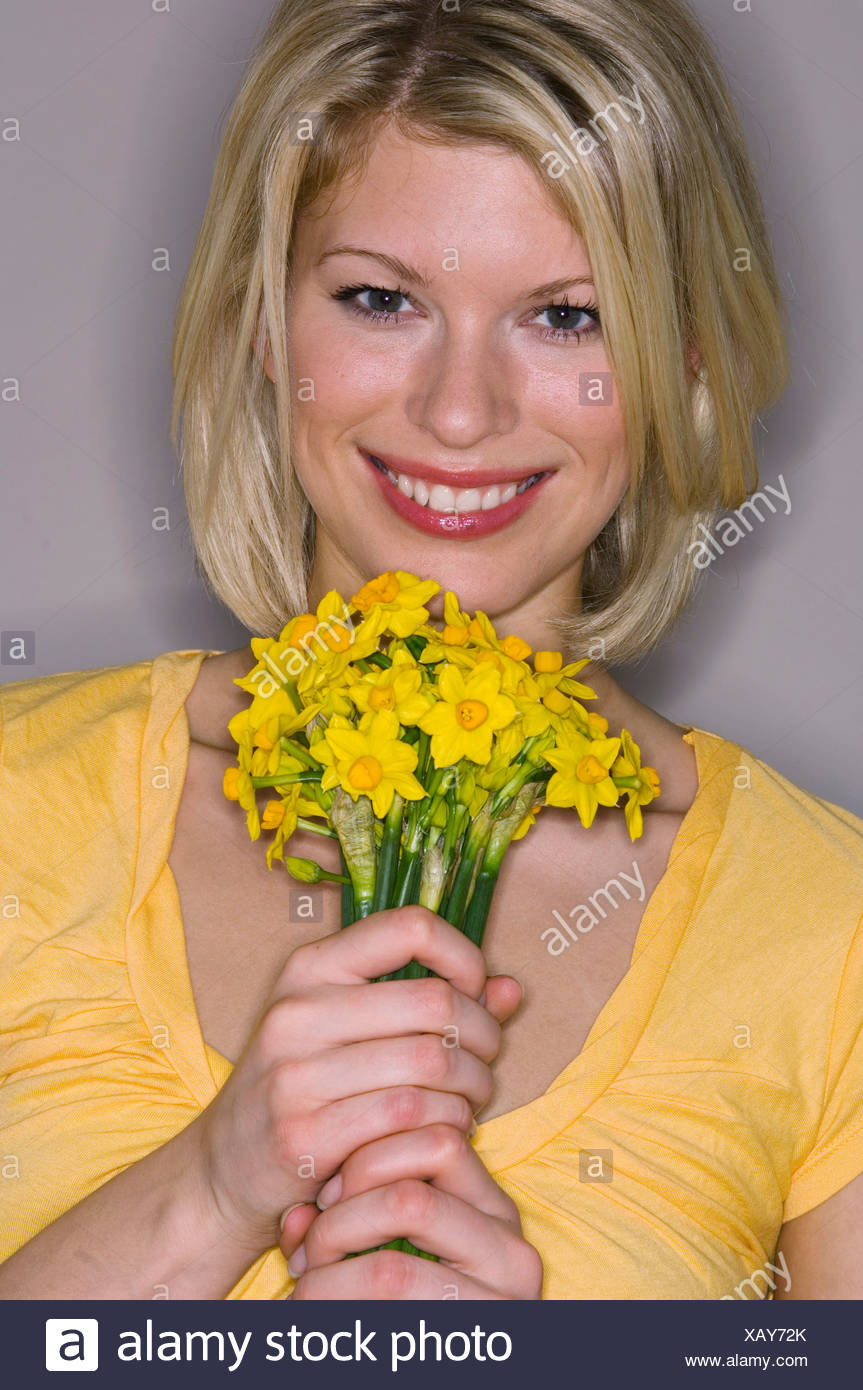 Female Shoulder Length Blonde Hair Wearing Yellow Scoop Neck Short