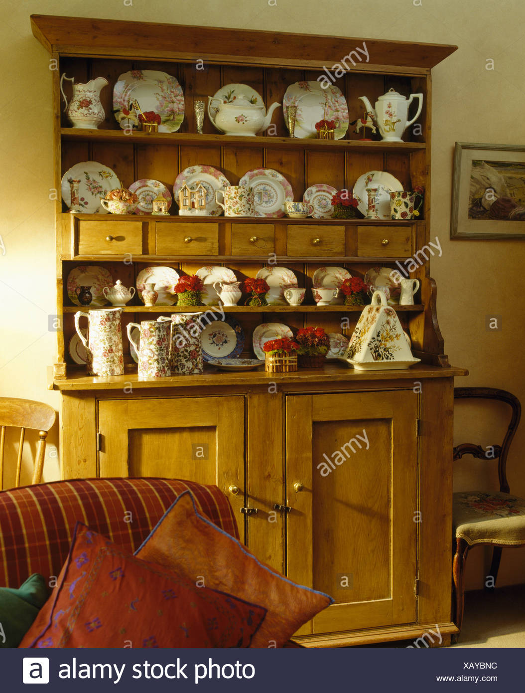 Collection Of Antique China On Old Pine Dresser In Cottage Dining