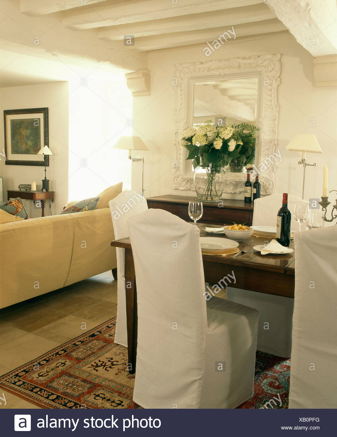 White Loose Covers On Chairs Around Table In White French