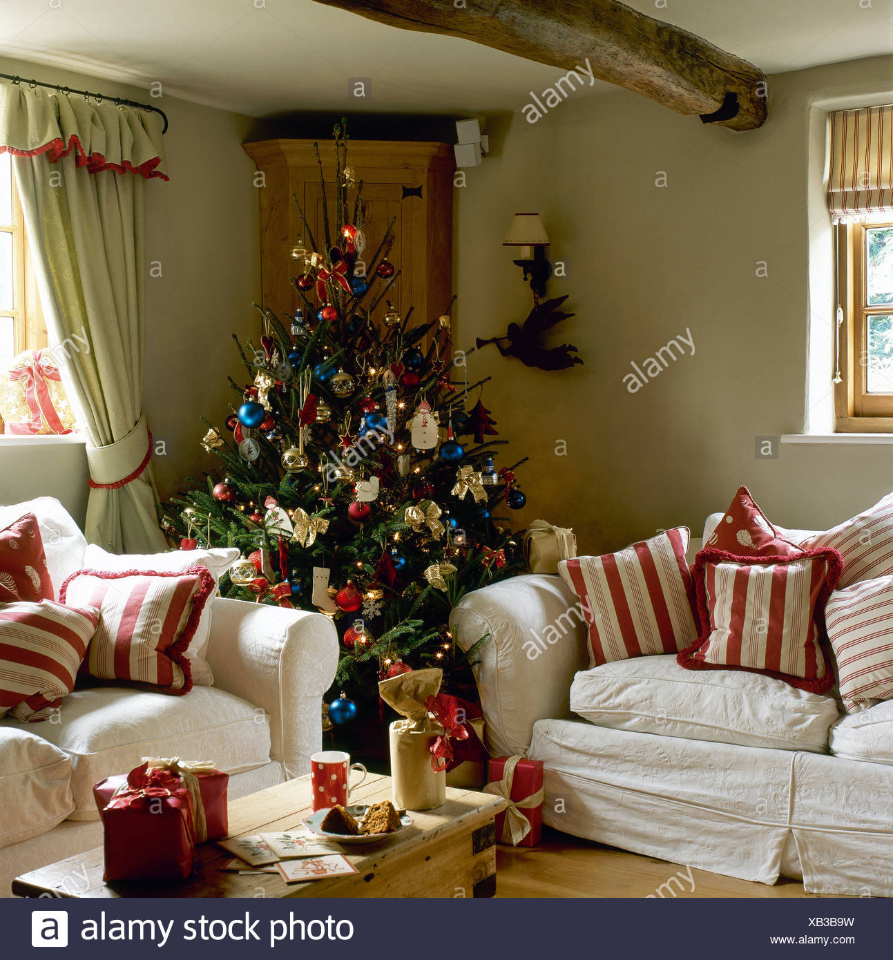 Decorated Christmas Tree In Corner Of Cottage Sitting Room With