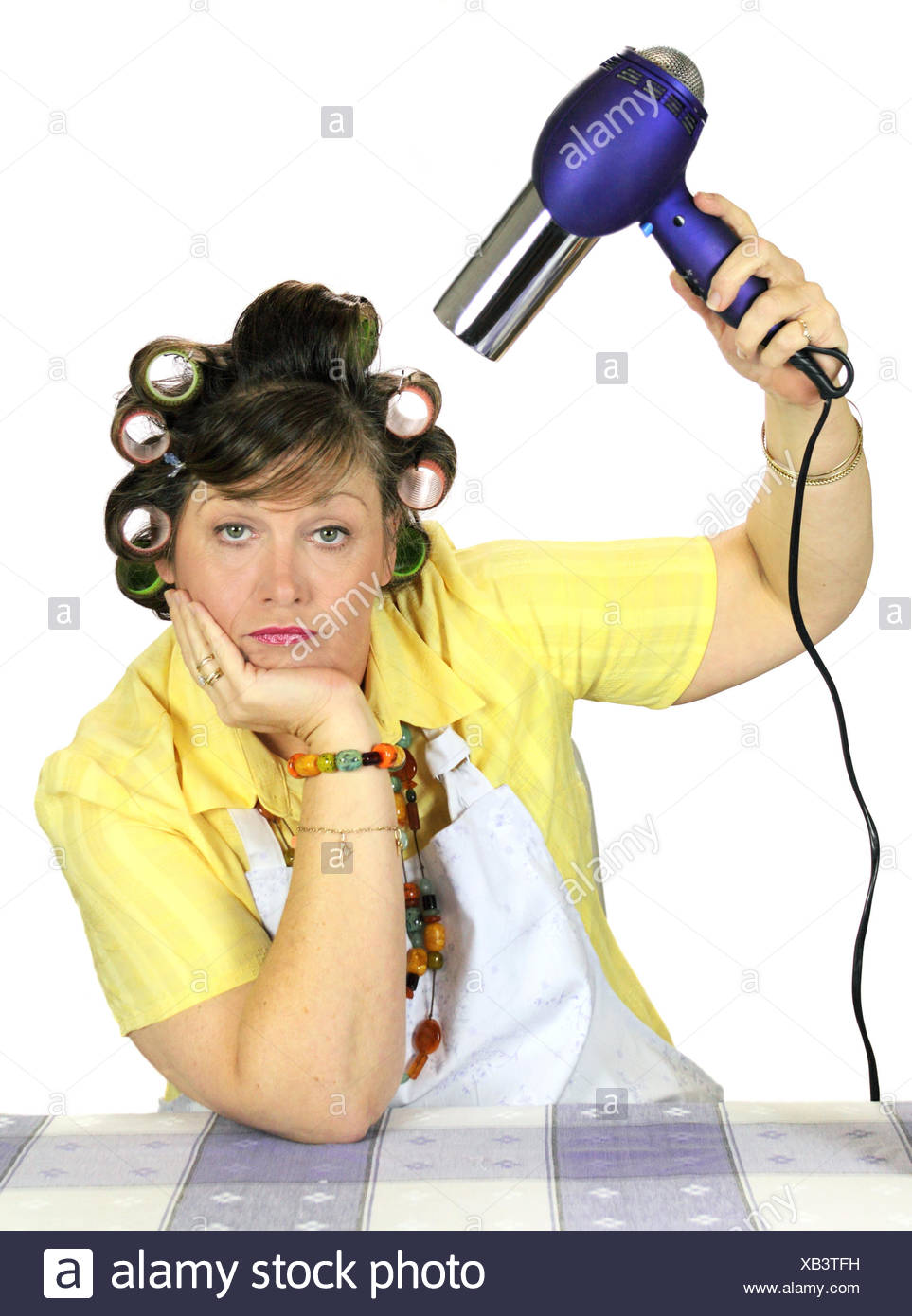 Mid Adult Woman With Rollers In Her Hair Under A Hair Dryer