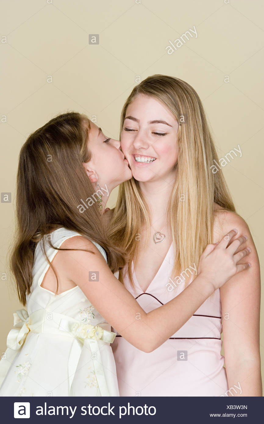 Two Sisters Kissing Stock