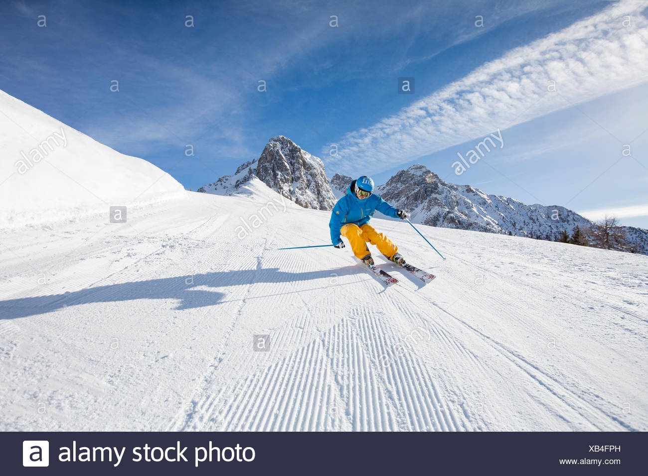 Skier with a helmet skiing down a slope, Mutterer Alm near ...