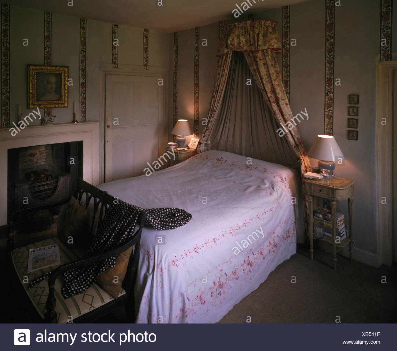 Lighted Lamps Either Side Of Bed With Coronet And Drapes And