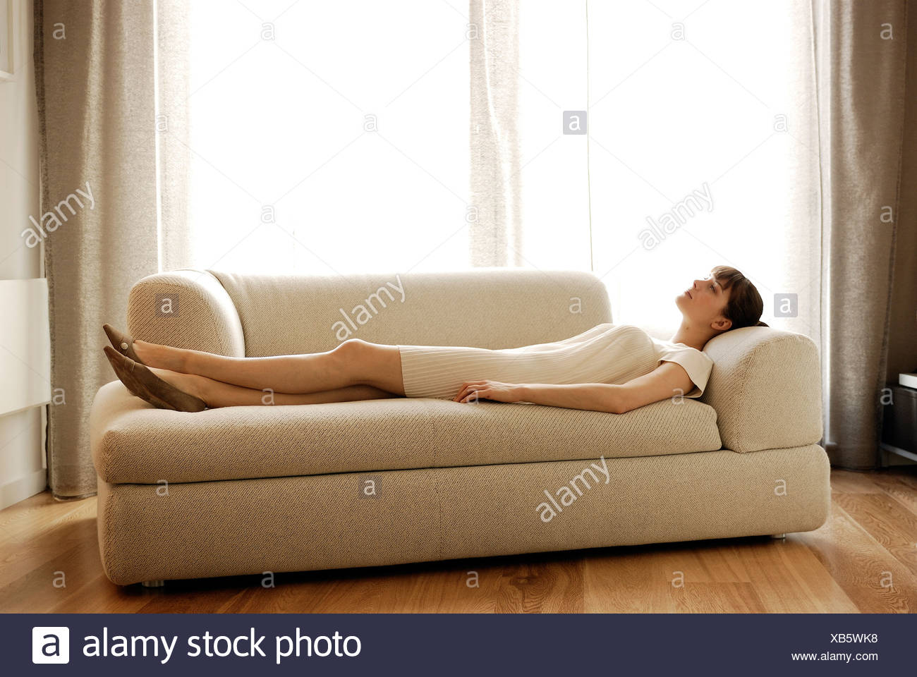 Woman Lying Down On Sofa Stock Photo 282257004 Alamy