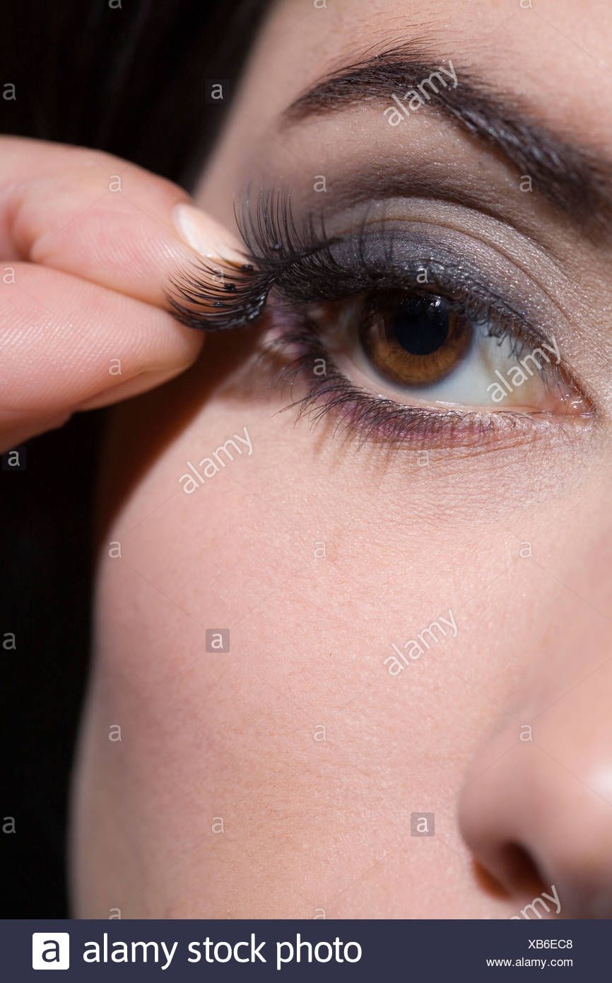 applying false eyelashes