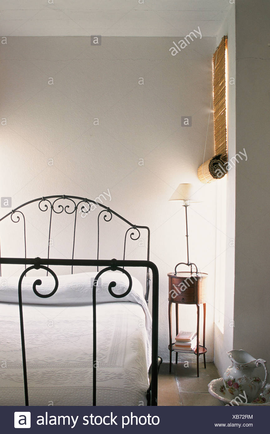 Bedroom White Coverlet Bedside Venetian Blind White Walls