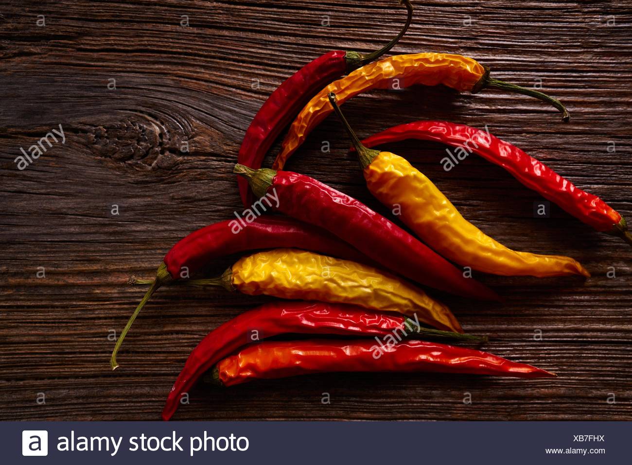 Dried Hot Chili Peppers On Aged Wood Background Stock Photo Alamy