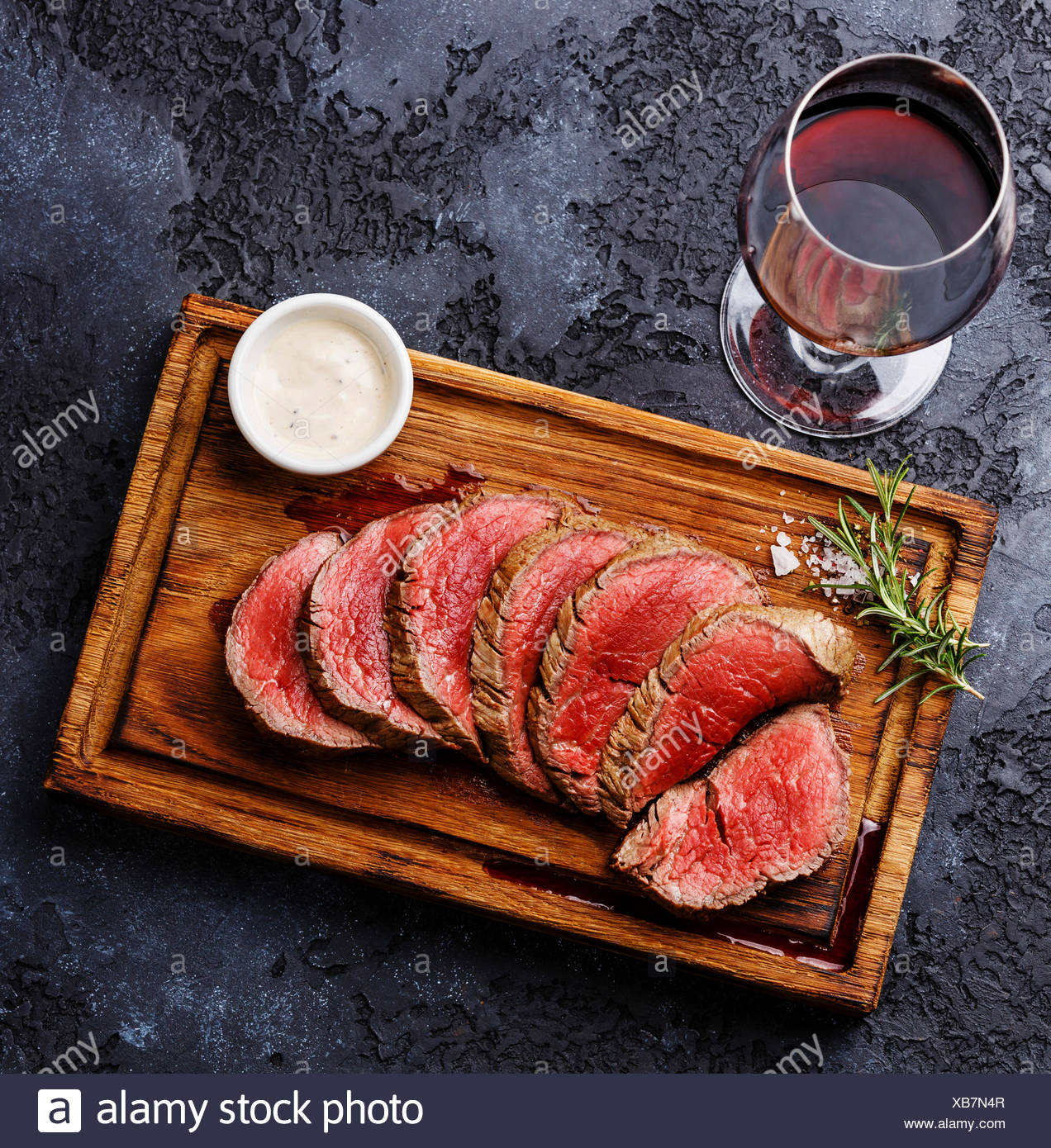 Sliced Grilled Tenderloin Steak Roastbeef And Pepper Sauce On Wooden Cutting Board And Red Wine On Dark Background Stock Photo Alamy