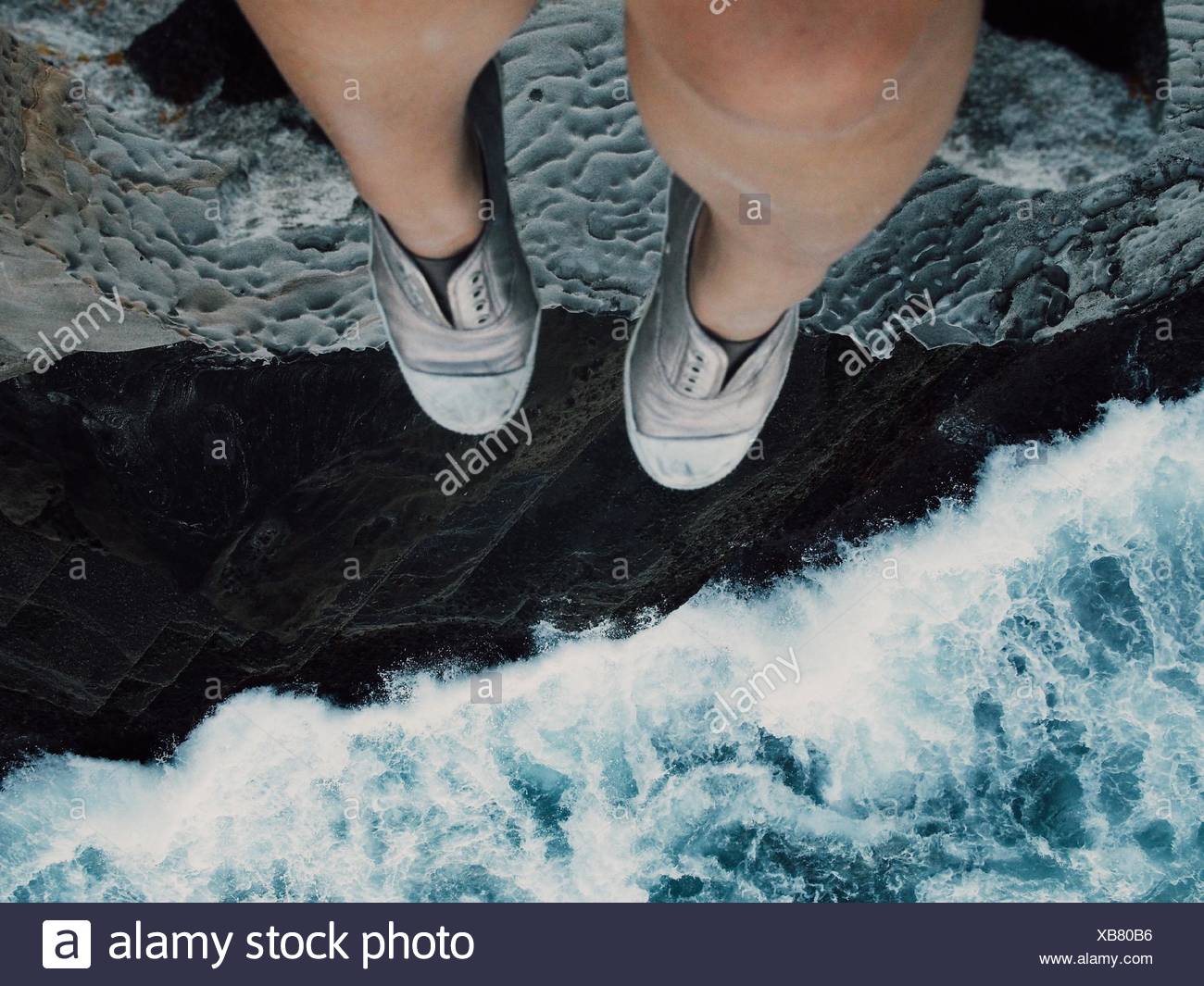 Woman Sitting On Cliff Stock Photo