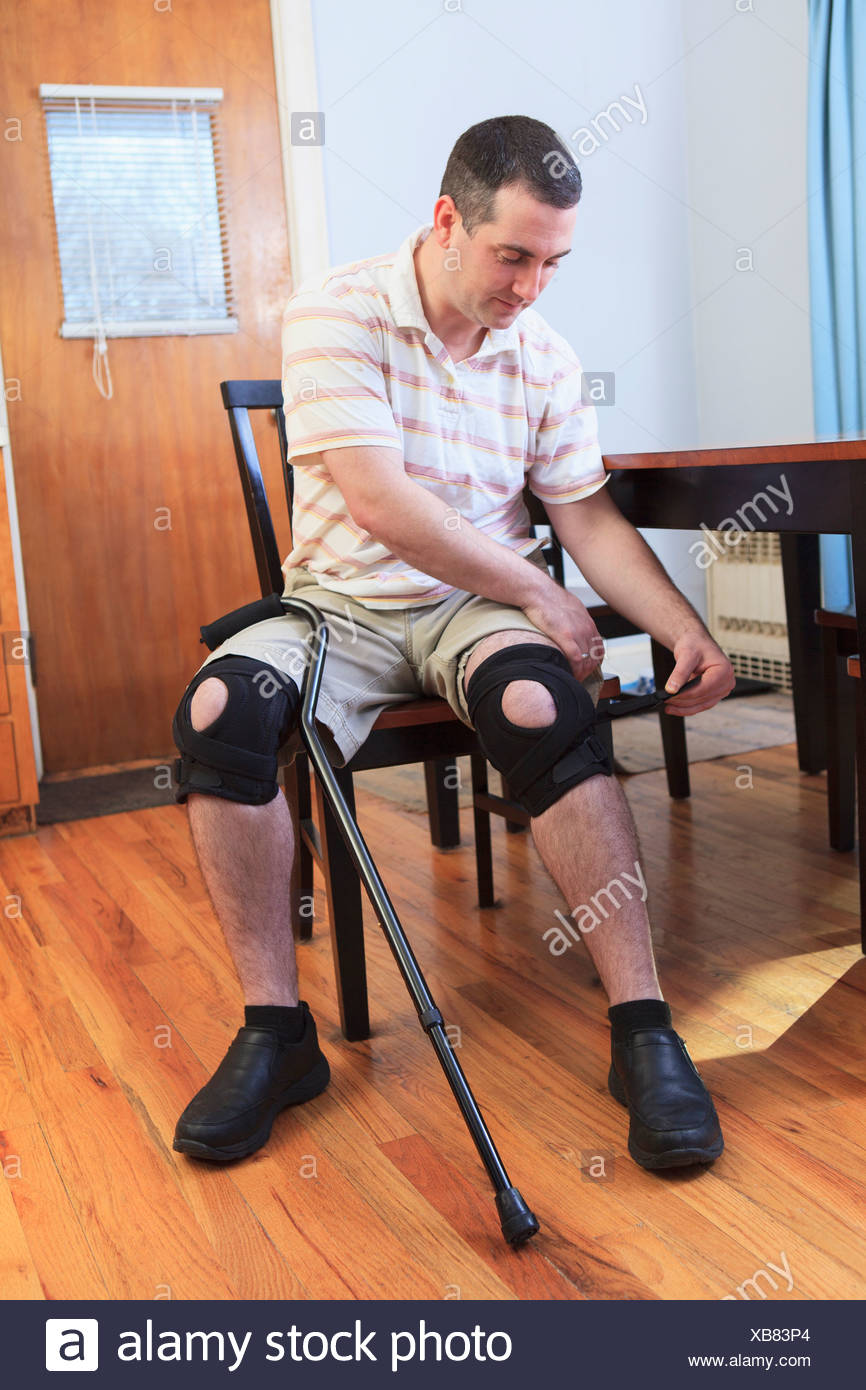 Man Adjusting Braces On His Knees After Anterior Cruciate Ligament Acl Surgery Stock Photo Alamy
