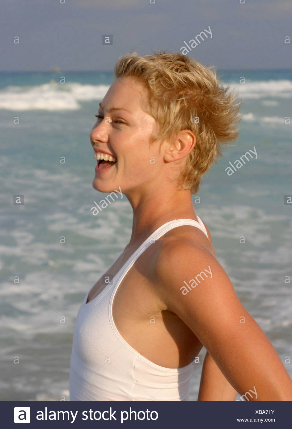 Profile Of Female Short Blonde Hair Wearing White Vest Top Looking
